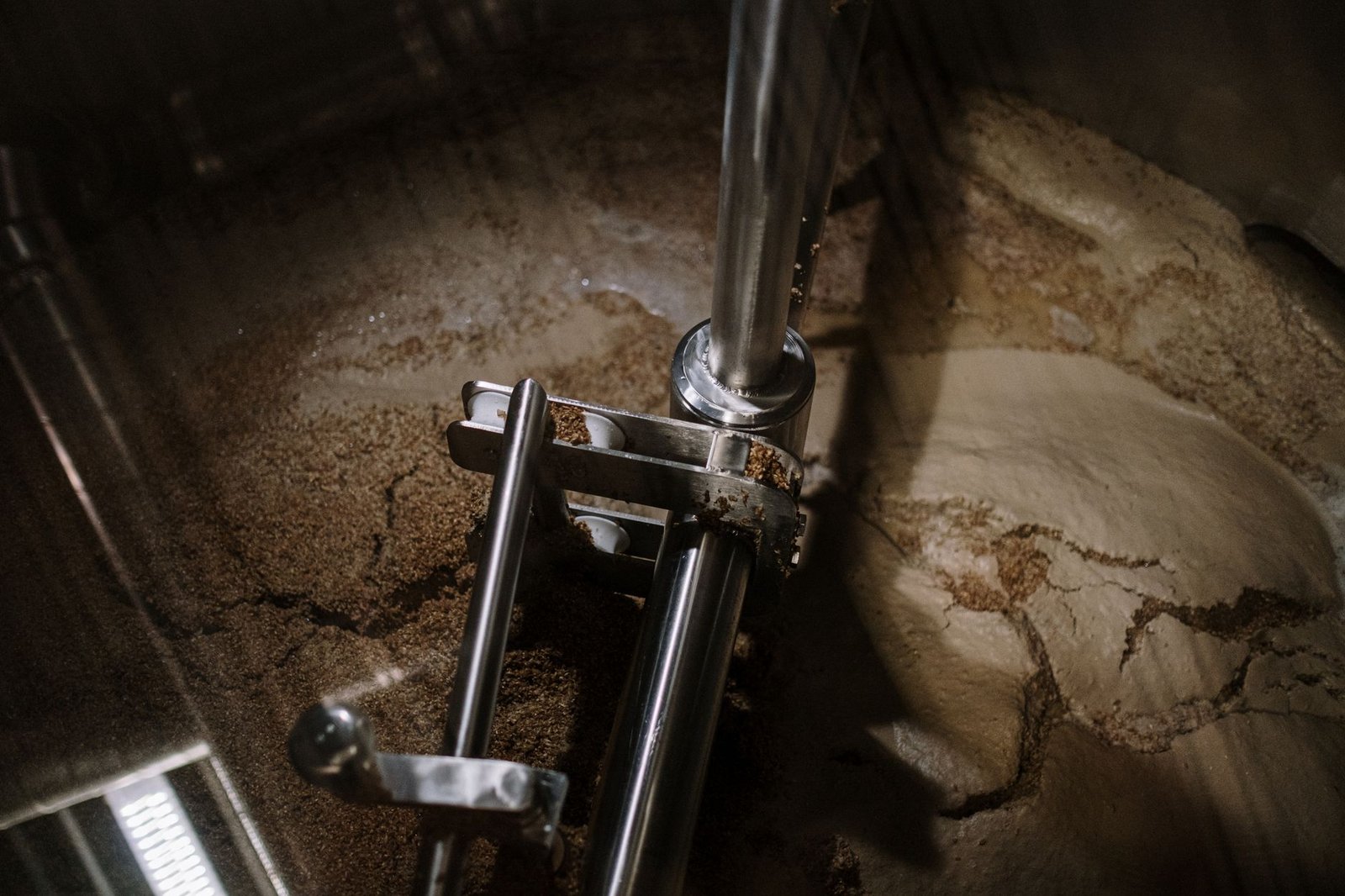 Industrial stainless steel mixing equipment on a factory floor